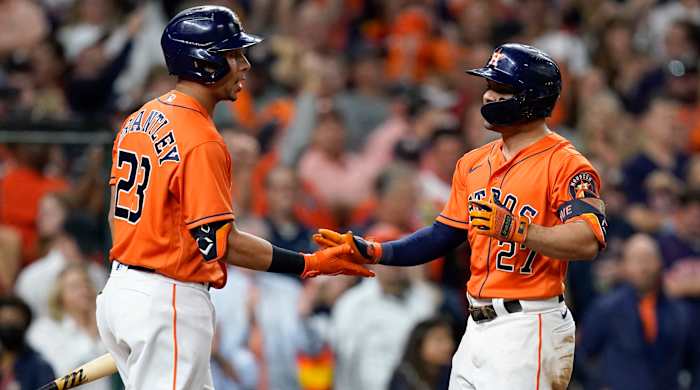 Oct 27, 2021; Houston, TX, USA; Houston Astros second baseman Jose Altuve (27) celebrates with left fielder Michael Brantley (23) after hitting a solo home run against the Atlanta Braves during the seventh inning in game two of the 2021 World Series at Minute Maid Park.